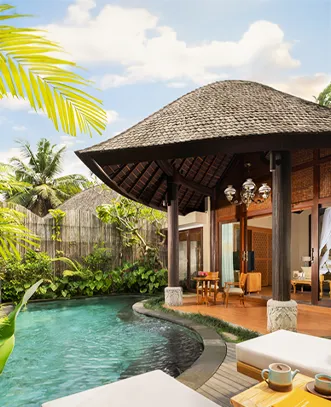 A private luxury villa in Bali featuring a curved swimming pool and a traditional thatched-roof pavilion