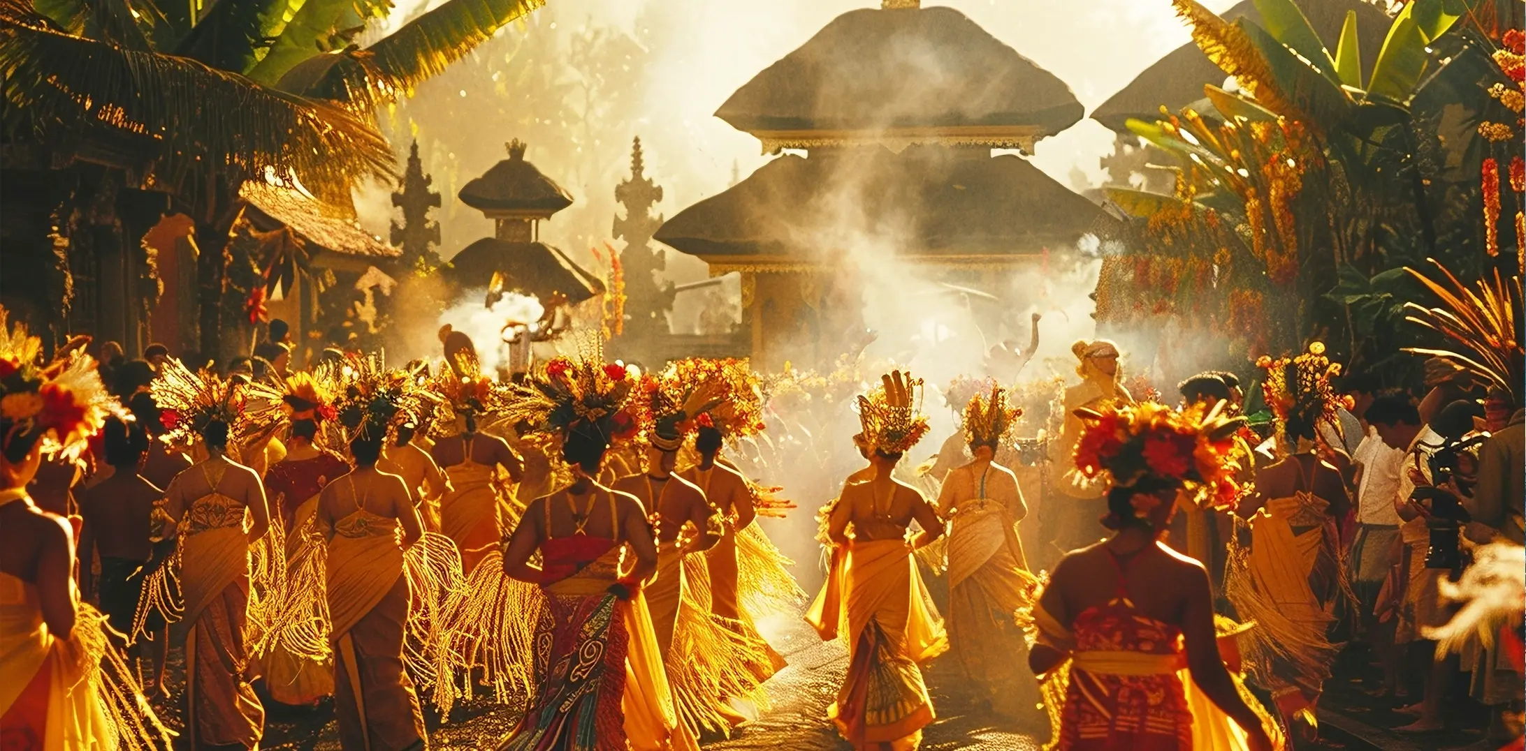 Balinese dancers in vibrant traditional costumes perform a cultural ceremony in a temple setting, bathed in golden light.