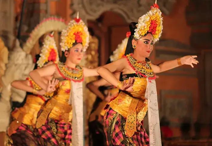 Dancers performing a traditional Balinese dance in ornate gold costumes.