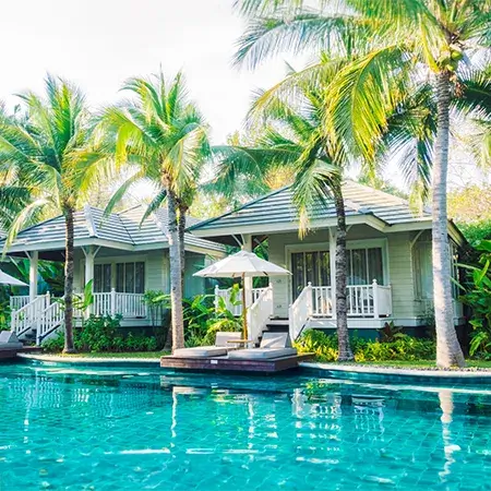 Luxury poolside villas and lush palms included in your premium bali holiday tour package.
