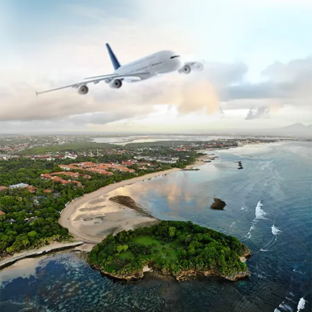 View from an airplane window showing a white wing over a soft blanket of white clouds under a clear blue sky