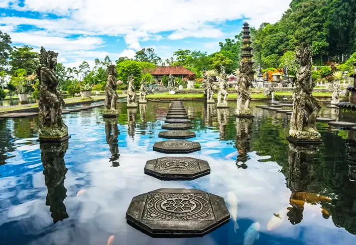 Steps leading to a serene pond at the temple, surrounded by lush greenery and tranquil atmosphere.