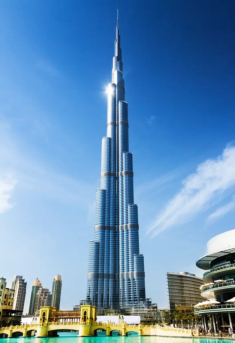 Burj Khalifa towering over Dubai's skyline, showcasing its iconic architecture against a clear blue sky.