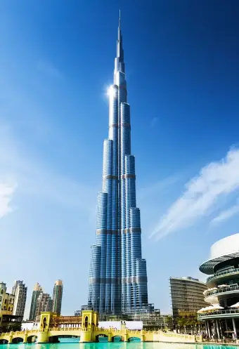Burj Khalifa towering over Dubai's skyline, showcasing its iconic architecture against a clear blue sky.