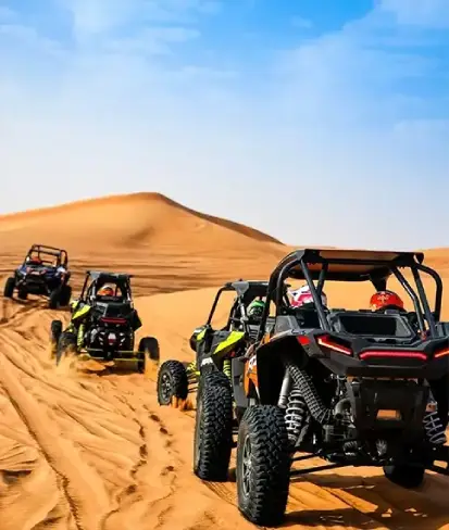 Four ATVs racing through the Dubai desert, showcasing an adventurous tour package experience.