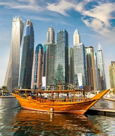 A scenic view of a boat in front of Dubai's towering buildings, perfect for a memorable city tour experience.