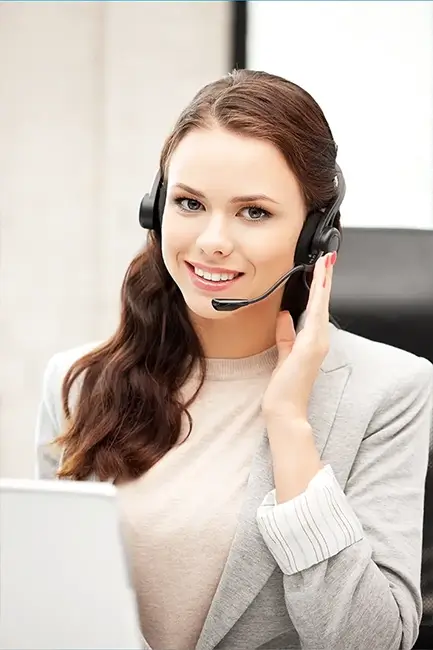 A friendly female travel consultant with a headset, highlighting Adeeba Tour and Travels' 24/7 personalized customer support.