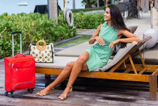 A woman relaxing at a luxury resort with her luggage.