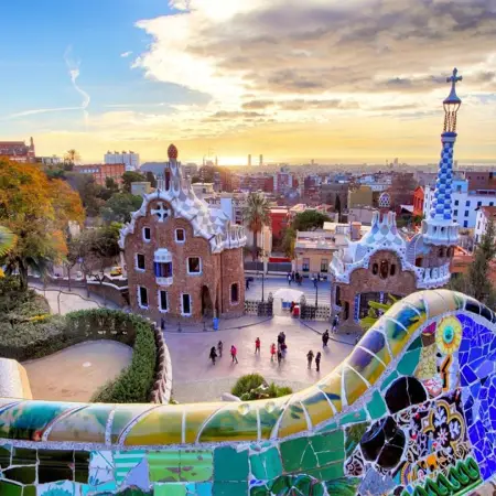 Colorful mosaics and whimsical architecture of Park Güell in Barcelona, showcasing Gaudí's unique design style.