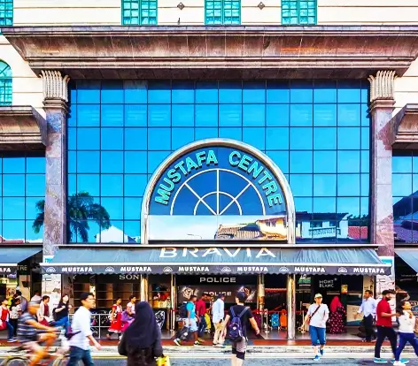 Busy shoppers at the entrance of Mustafa Centre in Little India, a top shopping destination included in our Singapore holiday packages.