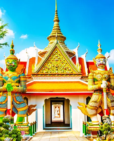 A close-up of the highly decorated, golden spires of the Grand Palace or a major Bangkok temple.