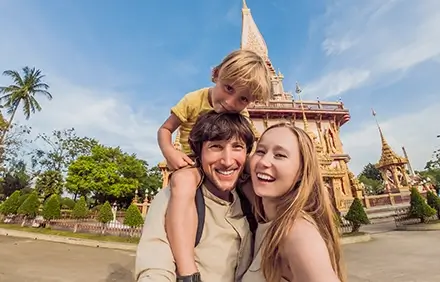 Happy family smiling at an animal park; fun-filled family holiday in thailand.
