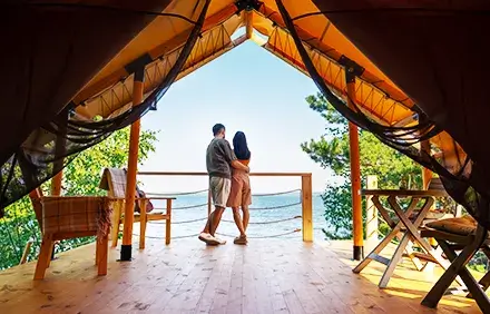 Romantic couple, sunset view, luxury resort balcony, Thailand honeymoon.