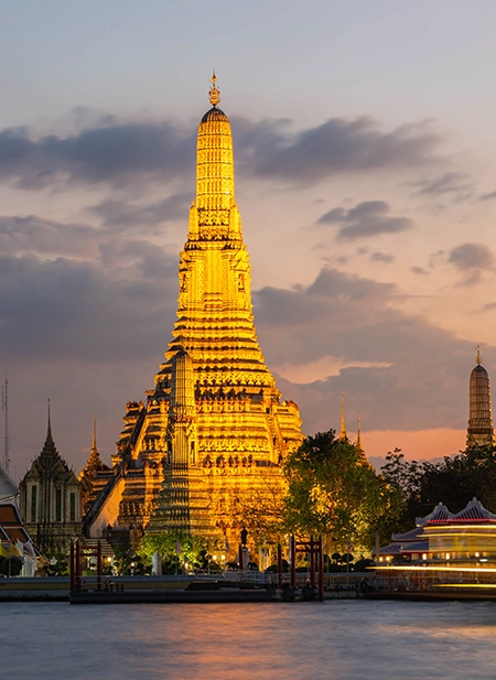 Dynamic Bangkok skyline showing ancient golden temples and modern high-rise buildings.