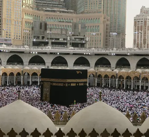 Pilgrims performing Umrah prayer near the Kaaba, included in the Umrah with Dubai Package.