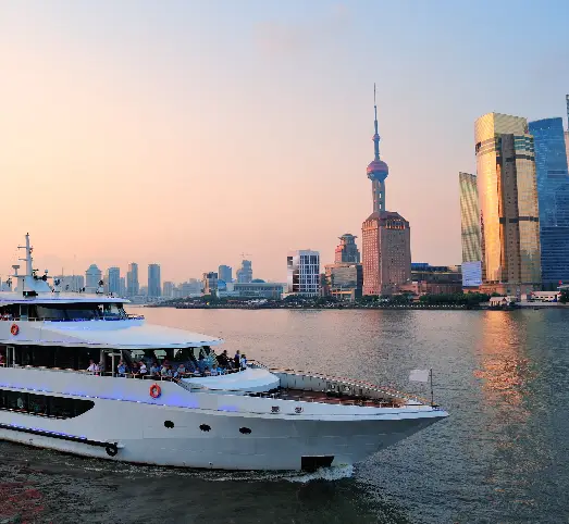 Luxury yacht sailing past modern city skyline.